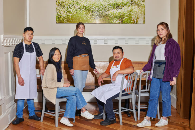 Plow restaurant business owner, Maxine Siu, and the restaurant staff are sitting in their San Francisco local restaurant.