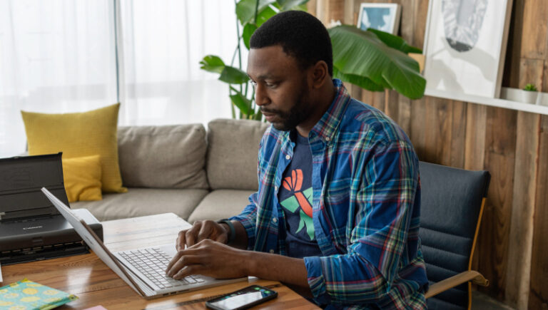 Man working on a laptop in office.
