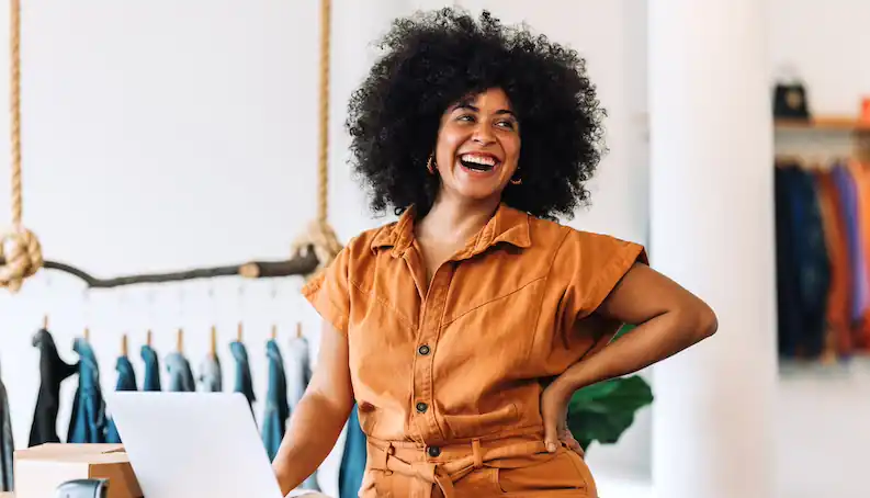 small business owner smiling about their commercial property insurance claim