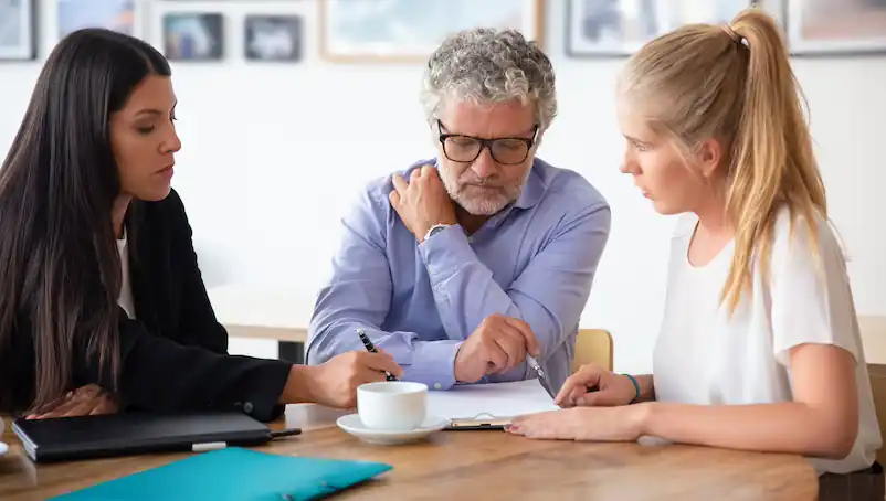 insurance agent explains workers’ compensation death benefits to clients