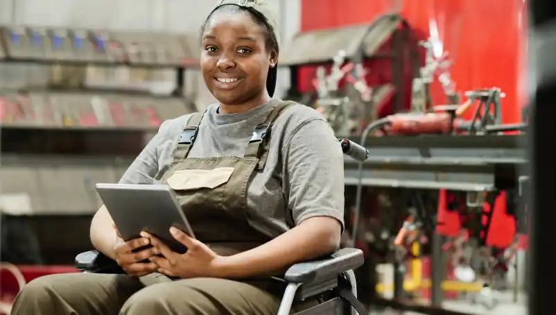 worker in a wheelchair uses a computer