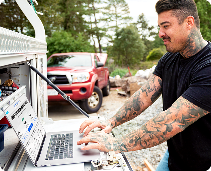 construction worker looking at computer